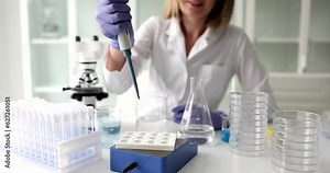 Scientist with pipette analyzes liquid to extract DNA and molecules in test tubes in laboratory. Research biochemistry, pharmaceutical medicine