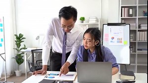 Collaborative Success: A dedicated mentor guides a young professional through data analysis.