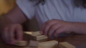 Girl Stacking Blocks On Table