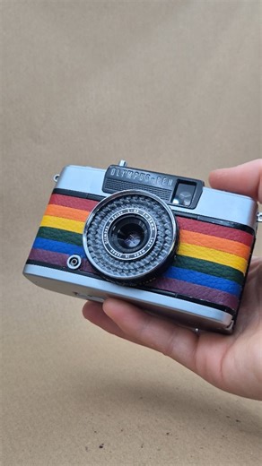This gorgeous Pride Flag Olympus Pen EE-2 could be yours.  It is available now on our website. This camera is a half-frame point and shoot film camera that has been reskinned by hand with the Pride flag. ️‍ Each strip of material is measured and cut by hand, which makes this camera a lot of time-consuming work. But worth it? Yeah. The profits from this camera go directly to LGBTQ+ fundraisers and charities. Shop now on our website. Link in bio. | Cameras By Max | Facebook