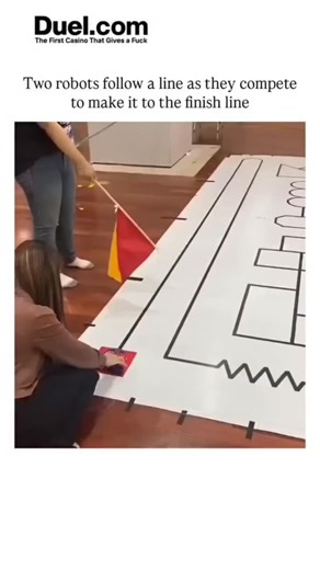 EXPLAINING VERSE on Instagram: "- The video depicts two small wheeled robots in a line-following race on a large white mat marked with black lines forming an electrical circuit diagram, navigating turns and intersections via infrared sensors in a student-led robotics event. - One robot consistently takes a longer looped path while the other shortcuts efficiently, illustrating programmed decision-making at junctions based on line detection algorithms, as noted in replies about path resets yieldin