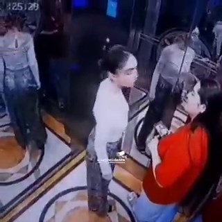 The security camera was quietly operating. A woman steps into the elevator, unaware of anything.