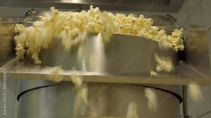 A Popcorn Shower as Kernels Pop Joyfully from the Industrial Machine