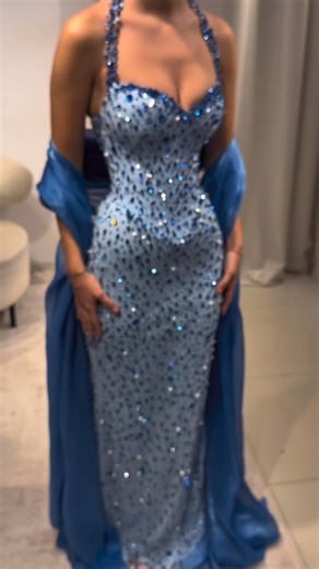 Reinee Couture| Luxury Custom Made Dresses on Instagram: "To order this light blue crystal dress DM @reineecouture This elegant evening dress features a sculpted corset bodice with delicate halter straps, fully adorned with hand-applied blue crystals that shimmer against a soft illusion base. Designed to contour the waist and hips, the fitted silhouette creates a smooth, feminine shape while the floor-length finish adds graceful movement. Refined yet striking, this couture piece is made to glow 