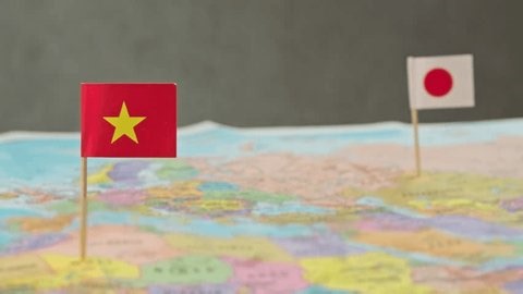 clip-3979203453-toy-airplane-between-japan-vietnam-flags-over