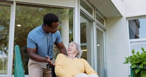 Nursing home, wheelchair and black man with old woman, person with a disability and rehabilitation. Recovery, senior lady and pensioner with caregiver and funny with help, support, volunteer or smile