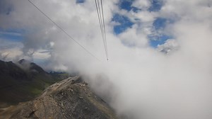 Premium stock video - Gondola ride in the swiss alps, altitude of the clouds, crossed during the ascent, gopro view