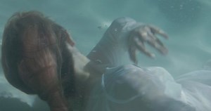 clip-1086000398-woman-white-dress-falls-water-struggles-breathe