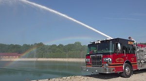 The Daviess County Fire Department has been training on drafting operations. Drafting is the process of using a pump to draw water from a static source, such as a farm pond or lake. In many rural areas of the county, hydrants are not readily available or provide insufficient flow to fight a large structure fire. Drafting can be a critical part of the water supply strategy. Lieutenant Ronnie Bobo, Engineer Will McCrady, and Firefighter Warren Goetz demonstrate the process, representing the Airpor