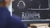 Analyzing An X-ray Dental Image At Dentist's Office