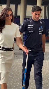 Carlos Sainz & girlfriend Rebecca arrive together in Abu Dhabi in stylr
