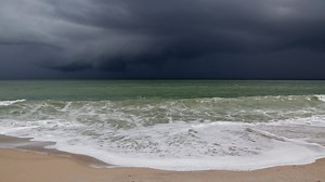 Beachgoers watch as an afternoon storm rolls through Wabasso Beach Park
