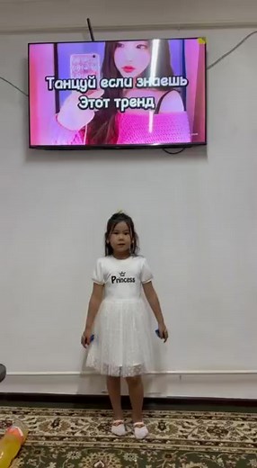 Young Performer in White Dress Shows Dance Moves