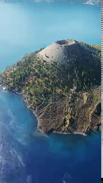 Aerial drone view of Wizard Island volcano cone rising from the deep blue waters of Crater Lake National Park, Oregon. Vertical Stock Video Footage - Alamy
