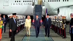 Macron puts on a brave face walking with wife after shoving row
