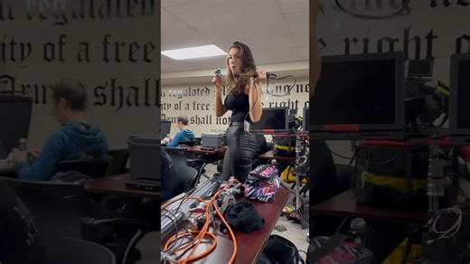 Model multitasks efficiently while filming on busy movie set