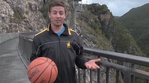 What happens when a spinning basketball is thrown off a dam