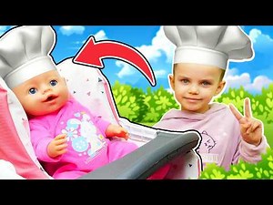 Maya is preparing to feed her baby doll some toy food in her new toy kitchen.