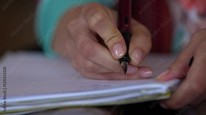 4k video detail view of a teacher's hand writing with a pen in a notebook. Concept video for starting of the new school year.