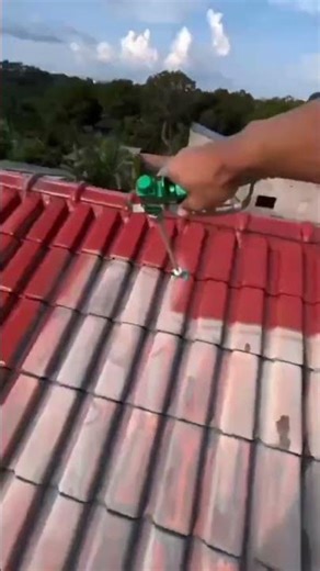 the process of painting a house roof using a special spray machine #shorts