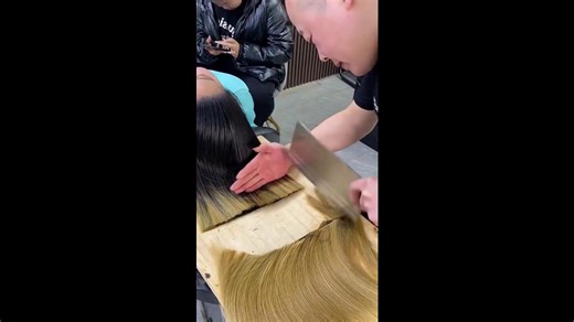 Chinese hairdresser cuts hair with a kitchen chopping knife