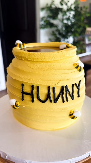 From the Hundred Acre Woods to your dessert table - our Winnie the Pooh Hunny Pot cake is as sweet as can bee! Pair with the cutest cake pops to make the perfect individual treat for any party. #heidisbakery #knoxville #knoxvillebakery #customcakes #knoxvilletennessee | Heidi's Bakery