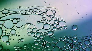 Abstract Colorful Food Oil Drops Bubbles and spheres Flowing on Water Surface