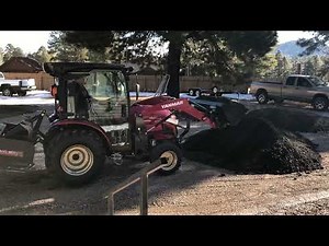 Yanmar YT235C grading asphalt millings.