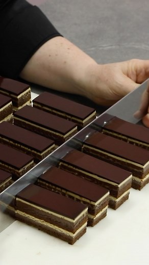 Kirsten Tibballs on Instagram: "Indulge in my reinvented Opera Petit Gâteau, a miniature masterpiece inspired by the iconic Opera Cake. Made up of layers of moist almond praline cake, rich chocolate cremeux, a creamy coffee mousseline creme, topped with a delicious chocolate glaze! The Opera Cake is said to be inspired by the elegant interior of the Opéra Garnier in Paris. While the exact origin remains a mystery, one thing’s for sure: it’s a delicious masterpiece. #Chocolate #Coffee #Almond #Pr