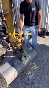 Changing the bucket on a Caterpillar Mini Excavator with the manual pin grabber quick attach w/bolt.