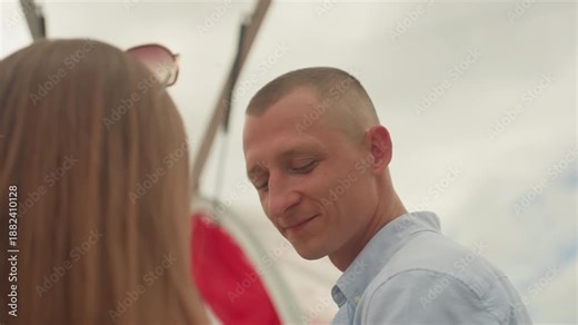 Intimate outdoor vow exchange under floral arch. White groom and partner share tender smiles and whispered vows beneath red drapery and hanging flowers, candid closeups capture affectionate glances,