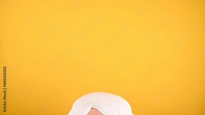 The woman stands bent over and rises sharply. Young brunette with a towel on her head, raises her head, smiles and looks directly into the camera