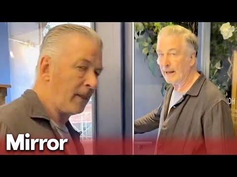 Angry Alec Baldwin slaps protester's phone