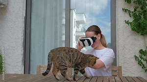 VR.woman uses VR glasses in everyday life at home, augmented reality, VR AR technologies, mixed reality,new future technology, futuristic environment,VR headset,immersive spaces