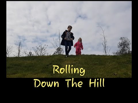 Children Rolling Down The Hill - active kids outdoor fun