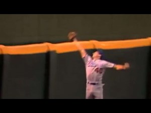 Bean leaps at the track to make a great catch