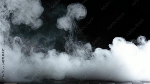 A clear glass beaker with boiling liquid and steam being released into the air