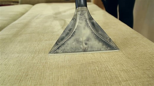 Vacuum cleaner cleaning a sofa - Free Stock Video