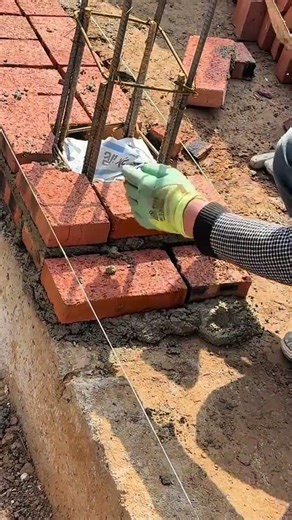 building a sturdy brick column with metal reinforcement and wet cement for a strong foundation base