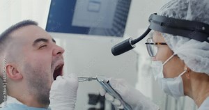 Examination of the larynx of a male patient with the help of medical instruments