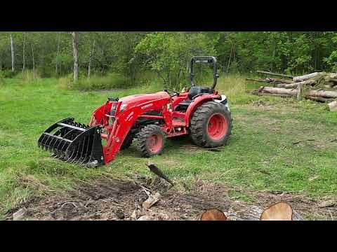 Kubota Tractor and Grapple moving Logs