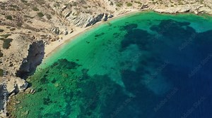 Aerial drone video of tropical paradise exotic island bay covered in limestone trees with emerald crystal clear beach visited by luxury yachts and sail boats in Caribbean destination