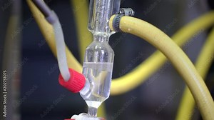 Production of perfume essences using steam in a distillation cube in a small alpine village. A mixture of water and aroma is condensed in a special glass flask. Real people.