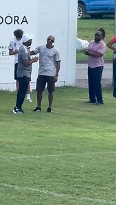 Football Legend Keith Kayamba Gumbs Spotted at Newtown Playfield – Time to Rename It in His Honor? ===================================== The Newtown Playfield came alive with nostalgia and excitement recently as St. Kitts football icon Keith "Kayamba" Gumbs made a rare appearance on the hallowed grounds where his legendary career began. The 52-year-old, who now resides in Australia, was spotted interacting with local football stalwart Lenny Lake and other notable figures, rekindling memories of 