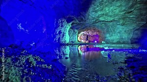 Illuminated cave with reflection in water in Viking Valley, Norway, serene and mysterious
