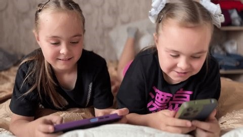 clip-3970068851-two-european-twin-girls-playing-video-games