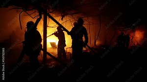 Brave firemen inside burning building. Fire extinguishing, fire brigade inside burning premises. House destroyed by fire