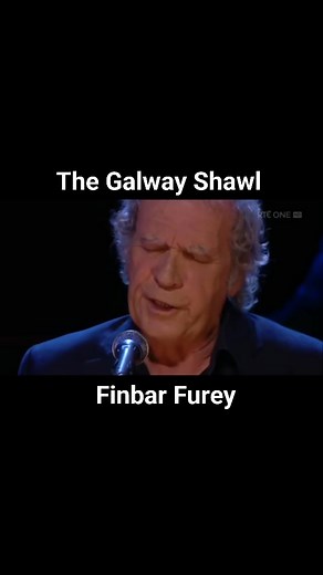 "The Galway Shawl" is a traditional Irish folk song about a traveling musician who has a brief, intense encounter with a beautiful but unadorned young woman in Oranmore, Galway. The song's meaning centers on themes of beauty, natural simplicity, and enduring love, as symbolized by the modest Galway shawl itself. The musician is smitten with the girl's natural charm and skills, playing music for her and her family, but leaves the next day for Donegal, unable to forget her and leaving his heart wi