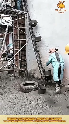 Skilled Workers Lifting Fresh Concrete Using a Chain Bucket System
