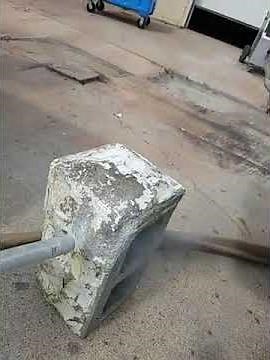 Removing paint from split face concrete block using dry ice blaster